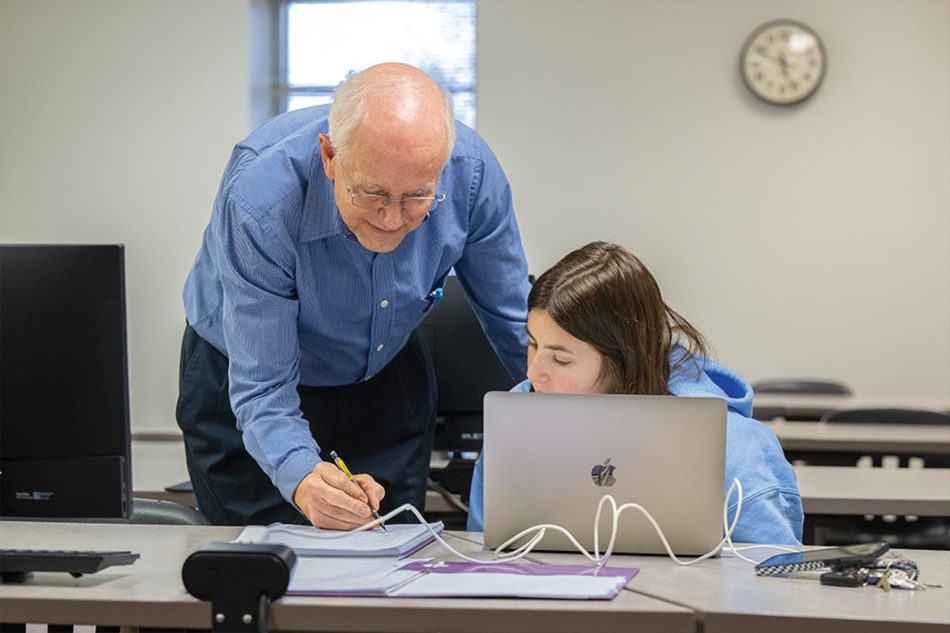 Photograph of a Franklin College professor instructing a student.