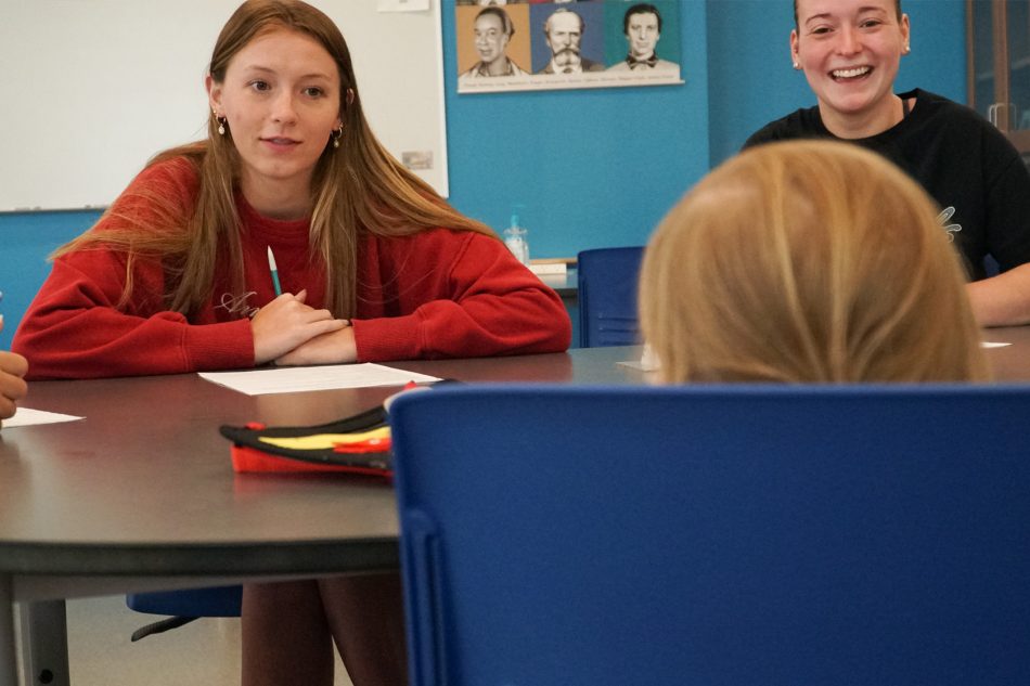 Photograph of Franklin College psychology students talking to a girl as part of a project.