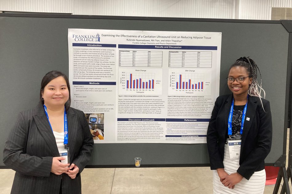 Photograph of Franklin College students next to a presentation of their research.