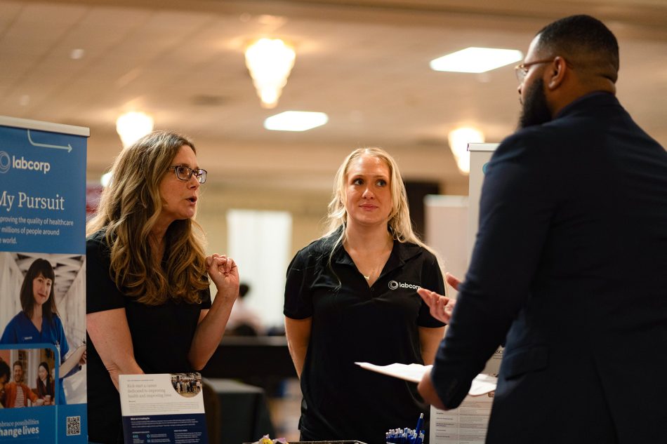 Photograph of people interacting during a career fair.
