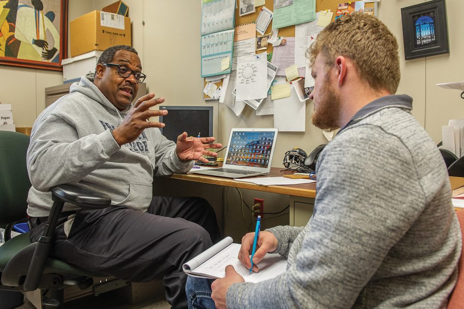 Photograph of Dr. Jason Jimerson, Department Chair and Professor of Sociology, talking to a student at Franklin College.