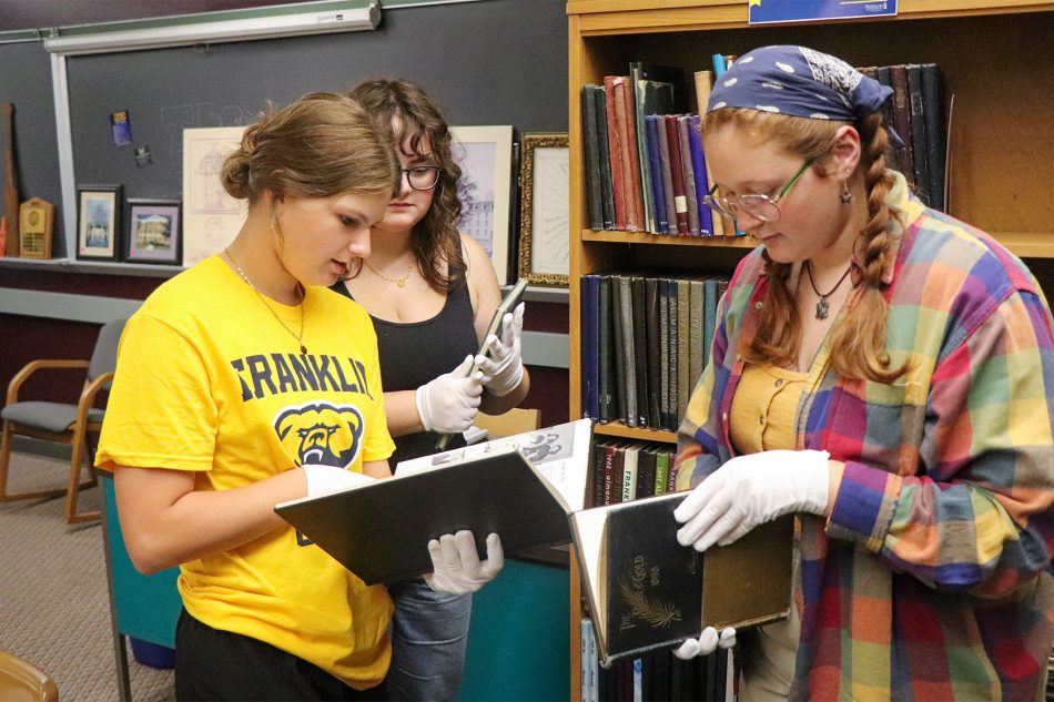 Photograph of Franklin College students looking at items in the college archives.