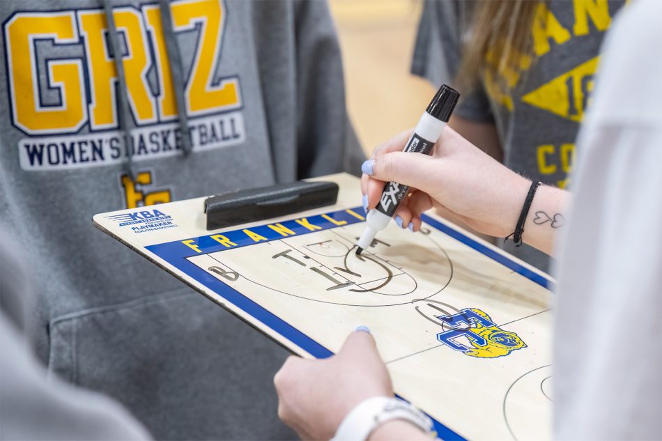 Photograph of a coach drawing up a play at Franklin College.