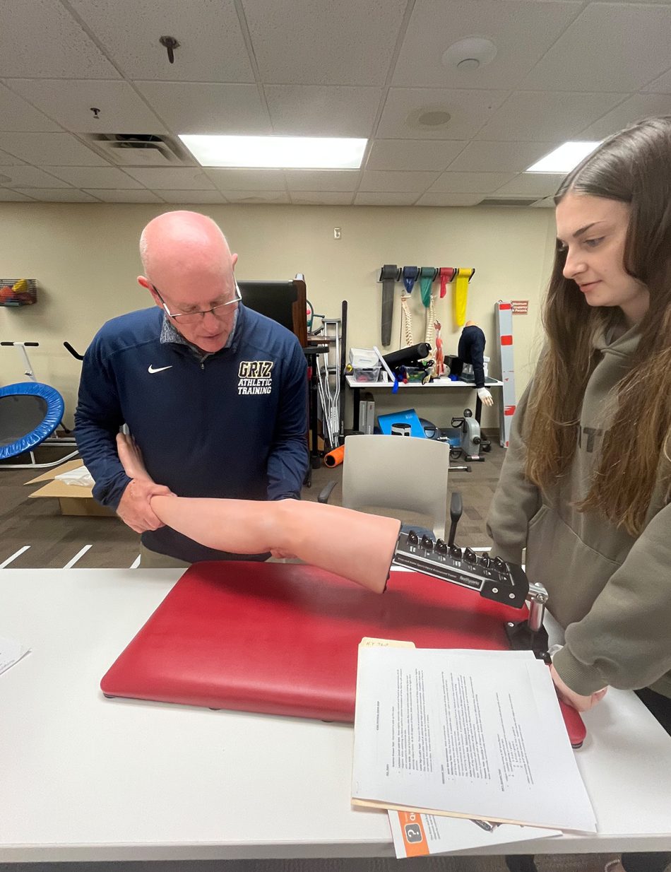 Photograph of people using a knee and ankle trainer at Franklin College.